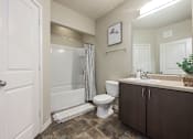 Thumbnail 9 of 40 - A bathroom with a toilet, sink, and shower.