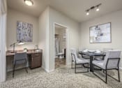 Thumbnail 5 of 40 - A room with a desk and a dining table.