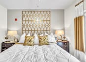 Thumbnail 18 of 39 - A bedroom with a large bed and two lamps on either side.