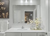 Thumbnail 22 of 48 - A white bathroom with a sink and a mirror.
