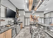 Thumbnail 31 of 39 - A modern kitchen with granite countertops and stainless steel appliances.