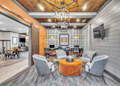 Thumbnail 26 of 39 - A modern living room with a wooden ceiling and grey chairs.