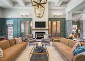 Thumbnail 42 of 48 - A living room with a fireplace and a large couch.