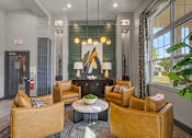 Thumbnail 43 of 48 - A living room with a fireplace and a large painting above it.