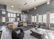 Thumbnail 29 of 38 - A modern living room with a black chair and a coffee table at Prosper Madison Oaks, Madison