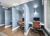Thumbnail 26 of 41 - A room with two chairs and two desks.