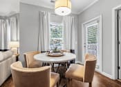 Thumbnail 10 of 41 - A dining room with a table and chairs.