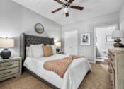 Thumbnail 11 of 41 - A bedroom with a bed, nightstands, and a ceiling fan.