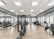 Thumbnail 24 of 38 - A spacious gym with a variety of equipment including treadmills, weights, and exercise machines at Prosper Madison Oaks, Madison, AL
