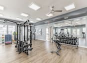 Thumbnail 25 of 38 - A spacious gym with a variety of equipment including treadmills, weights, and a bench press at Prosper Madison Oaks, Madison, AL