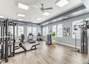 Thumbnail 28 of 38 - A spacious home gym with a variety of exercise equipment at Prosper Madison Oaks, Madison, AL