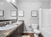 Thumbnail 13 of 41 - A bathroom with a sink, toilet, and bathtub.