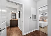 Thumbnail 16 of 41 - A bedroom with a white bed and a brown dresser.