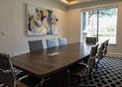 Thumbnail 28 of 30 - a conference room with a large table and chairs and a painting on the wall