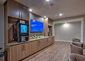 Thumbnail 12 of 30 - A room with wooden floors and a television on a wooden cabinet.