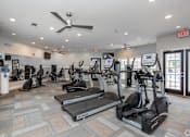 Thumbnail 14 of 25 - A Gym with Elliptical Machines at Mill Creek Run Apartments, Macon, 31216