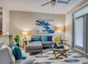 Thumbnail 4 of 19 - a living room with a couch and a ceiling fan at The Mark, San Antonio, TX