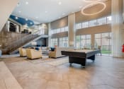Thumbnail 13 of 19 - a large living room with a piano and a spiral staircase at The Mark, Texas, 78230