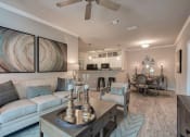 Thumbnail 10 of 14 - a living room with a couch and a table at Sterling Creek, Richmond Hill, GA