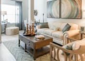 Thumbnail 11 of 14 - a living room with a couch and a table at Sterling Creek, Richmond Hill, 31324