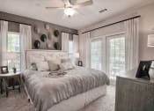 Thumbnail 13 of 14 - a bedroom with a bed and a ceiling fan at Sterling Creek, Georgia