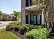 Thumbnail 2 of 10 - a building with a front door and a landscaped yard at Mill Creek Run, Macon, GA