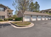 Thumbnail 5 of 10 - a building with garages and a street in front of it at Mill Creek Run, Macon, 31216