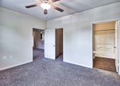 Thumbnail 8 of 10 - an empty living room with a ceiling fan and a closet at Mill Creek Run, Macon, GA 31216