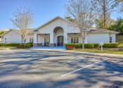 Thumbnail 1 of 20 - the front of a white building with a parking lot at Spring Creek Apartments, Crestview