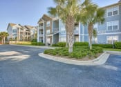 Thumbnail 8 of 20 - a row of houses with palm trees in front of them at Spring Creek Apartments, Florida