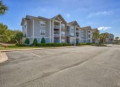 Thumbnail 10 of 20 - an empty parking lot in front of an apartment building at Spring Creek Apartments, Crestview, FL
