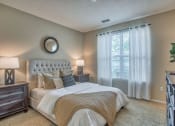 Thumbnail 15 of 20 - a bedroom with a large bed and a window at Spring Creek Apartments, Florida