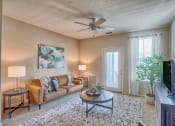 Thumbnail 17 of 20 - a living room with a couch and a ceiling fan at Spring Creek Apartments, Crestview, FL 32536