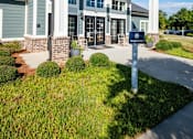 Thumbnail 4 of 74 - A building with a white and blue facade with a sign in front at Waterleaf at Neely Ferry Apartments, Simpsonville, South Carolina
