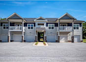 Thumbnail 6 of 74 - A row of houses with garages and driveways at Waterleaf at Neely Ferry Apartments, Simpsonville, South Carolina
