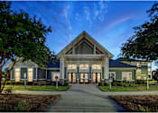 Thumbnail 8 of 74 - A modern building with a large front entrance and a pathway leading to it at Waterleaf at Neely Ferry Apartments, Simpsonville, SC