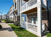 Thumbnail 10 of 74 - A row of apartment buildings with white railings and balconies at Waterleaf at Neely Ferry Apartments, Simpsonville, 29680