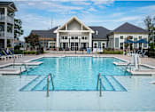 Thumbnail 15 of 74 - A large swimming pool in front of a building at Waterleaf at Neely Ferry Apartments, South Carolina