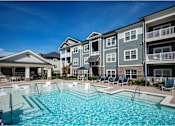 Thumbnail 16 of 74 - A swimming pool in front of apartment buildings at Waterleaf at Neely Ferry Apartments, South Carolina 29680