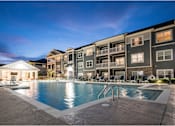 Thumbnail 20 of 74 - A large swimming pool is surrounded by apartment buildings at Waterleaf at Neely Ferry Apartments, Simpsonville, SC 29680