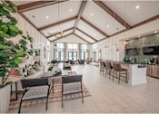 Thumbnail 27 of 74 - A large open living room with a kitchen area in the background at Waterleaf at Neely Ferry Apartments, Simpsonville, SC