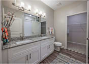 Thumbnail 36 of 74 - A bathroom with a toilet, sink, and mirror at Waterleaf at Neely Ferry Apartments, Simpsonville, SC 29680