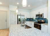 Thumbnail 45 of 50 - a kitchen with white cabinets and a counter top at Legacy at Cibolo, Boerne, TX