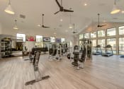 Thumbnail 26 of 50 - a gym with weights and cardio equipment and windows at Legacy at Cibolo, Boerne, TX