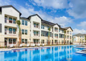 Thumbnail 2 of 50 - a large swimming pool in front of an apartment building at Legacy at Cibolo, Boerne, TX