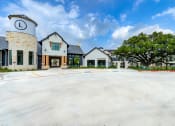 Thumbnail 1 of 50 - an empty parking lot in front of a building with trees at Legacy at Cibolo, Boerne, TX