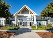 Thumbnail 47 of 74 - A large building with a triangular roof and a covered entrance at Waterleaf at Neely Ferry Apartments, Simpsonville, 29680