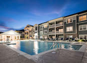 Thumbnail 60 of 74 - A large swimming pool is surrounded by apartment buildings at Waterleaf at Neely Ferry Apartments, Simpsonville, SC