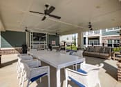 Thumbnail 48 of 74 - A patio with a white table and chairs and a ceiling fan at Waterleaf at Neely Ferry Apartments, Simpsonville, South Carolina