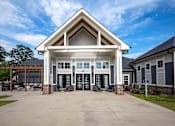 Thumbnail 42 of 74 - A large building with a white and brown roof and a covered patio area at Waterleaf at Neely Ferry Apartments, Simpsonville